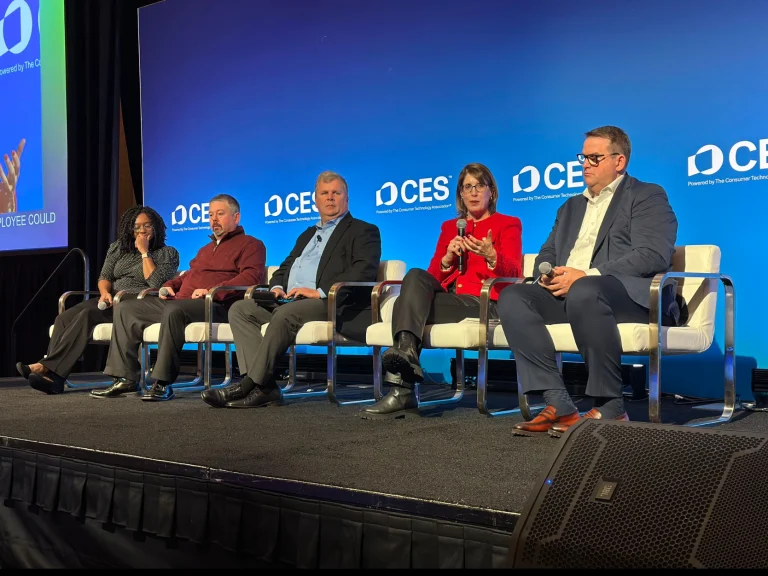 Lauren Lobrano speaking during a panel discussion at CES on accessibility and inclusive technology, alongside fellow panelists and a moderator.